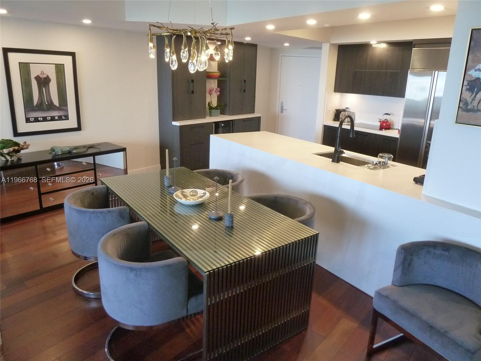 400 Alton Road, Unit 905 Miami Beach, FL 33139 - Photo 8 of 30 a kitchen with a dining table chairs and living room
