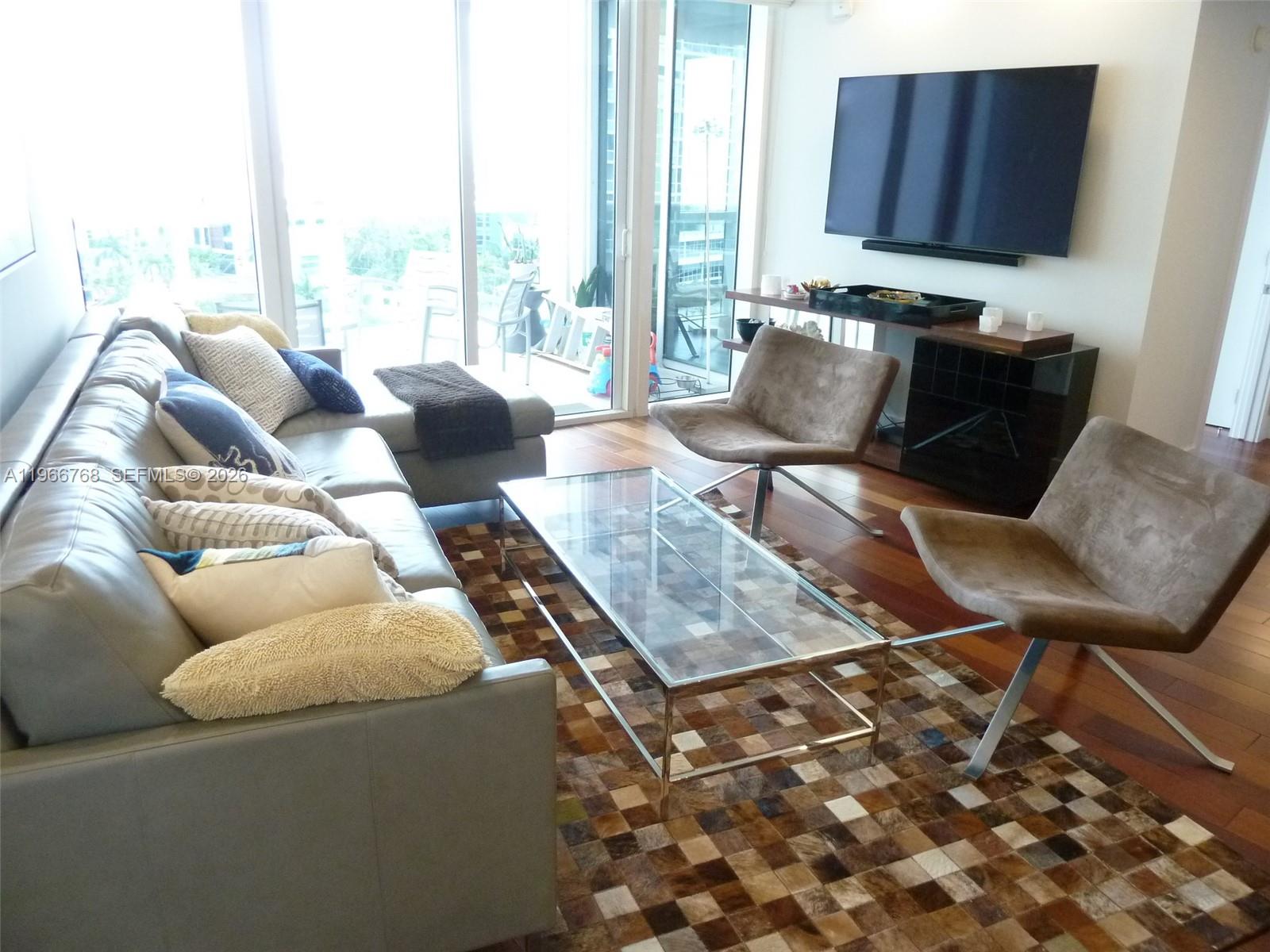 400 Alton Road, Unit 905 Miami Beach, FL 33139 - Photo 10 of 30 a living room with furniture and a window