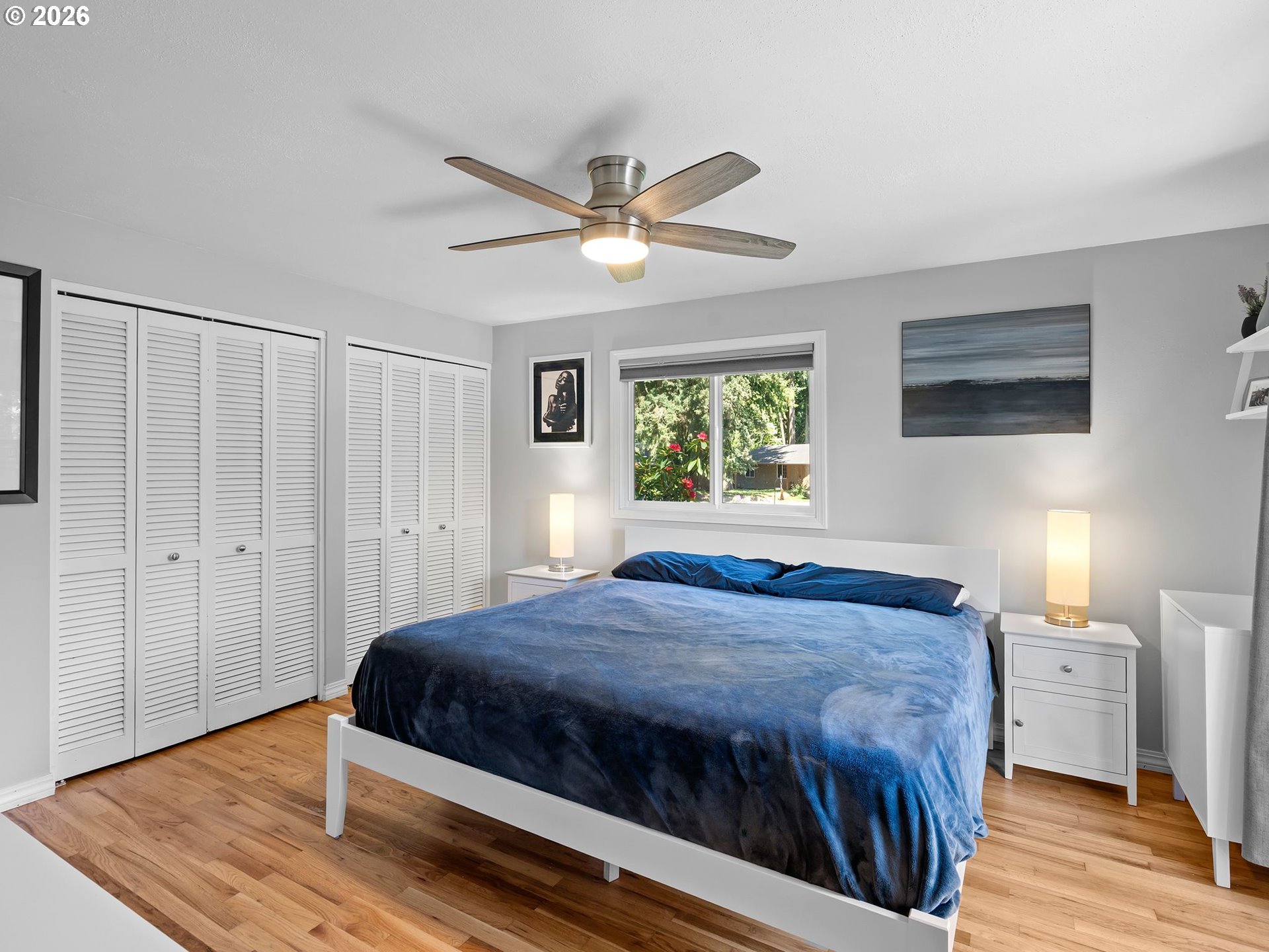 2615 Southwest 175th Avenue Beaverton, OR 97003 - Photo 18 of 42 a bedroom with a large bed a chandelier and a window