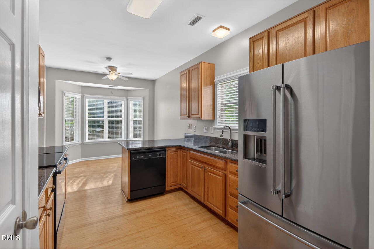 5325 Bartram Place Raleigh, NC 27617 - Photo 11 of 31 a large kitchen with stainless steel appliances granite countertop a refrigerator and a sink