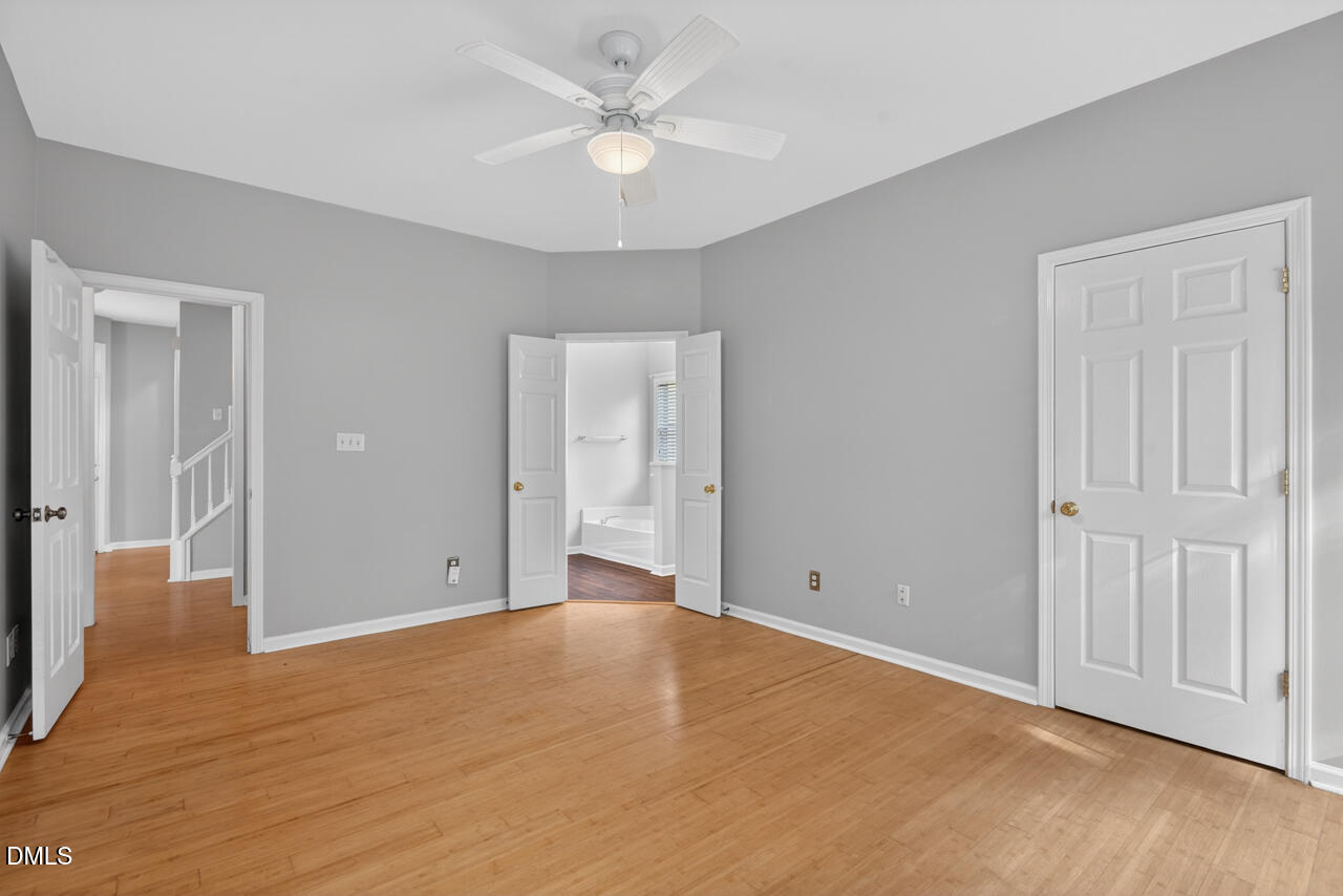 5325 Bartram Place Raleigh, NC 27617 - Photo 15 of 31 a view of an empty room with closet and a ceiling fan