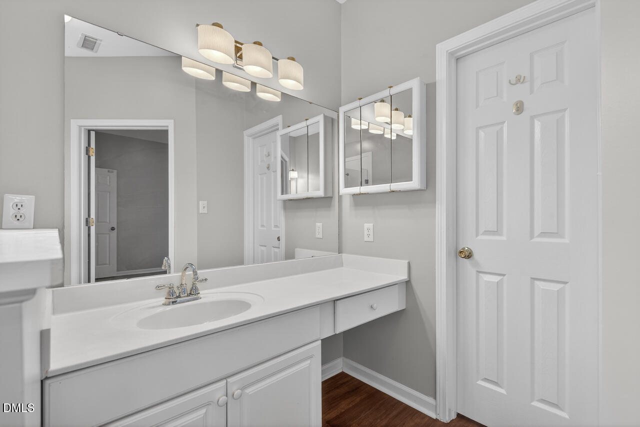 5325 Bartram Place Raleigh, NC 27617 - Photo 18 of 31 a bathroom with a double vanity sink and a mirror