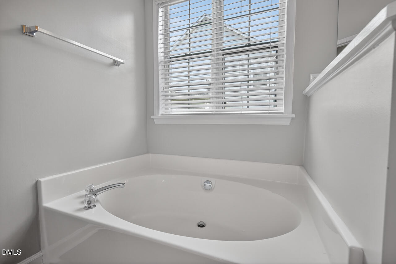 5325 Bartram Place Raleigh, NC 27617 - Photo 21 of 31 a white bath tub sitting in a bathroom