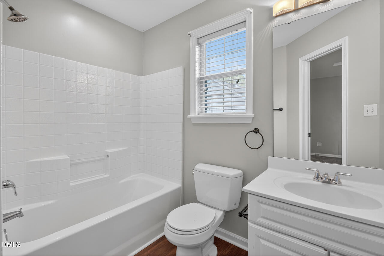 5325 Bartram Place Raleigh, NC 27617 - Photo 28 of 31 a white toilet sitting next to a bath tub