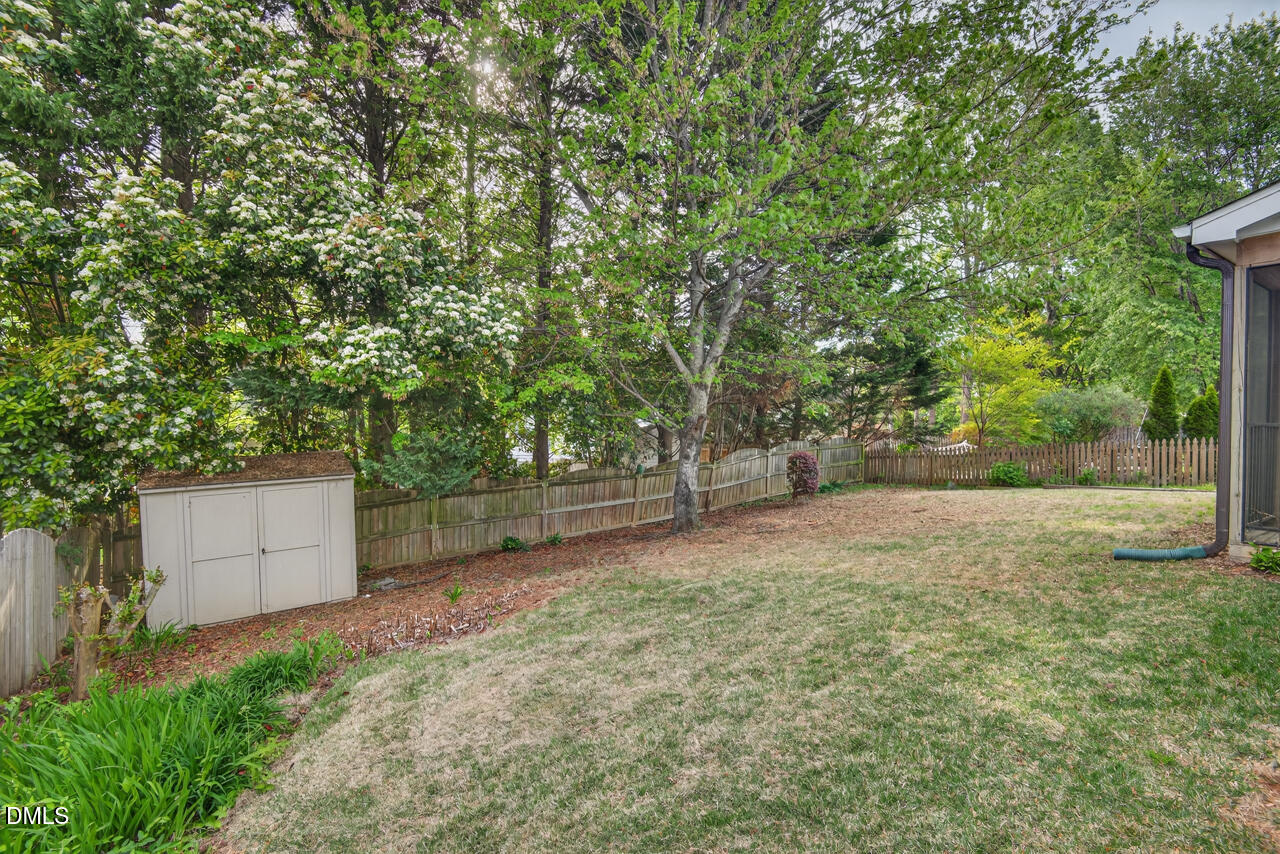 5325 Bartram Place Raleigh, NC 27617 - Photo 31 of 31 a backyard of a house with lots of green space