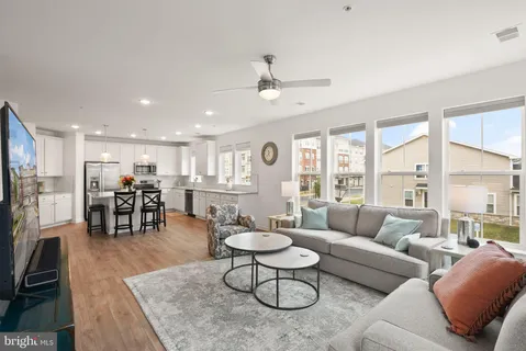 a living room with furniture a dining table and a fireplace