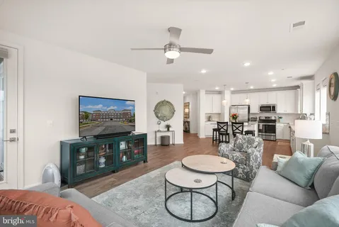 a living room with furniture and wooden floor