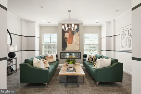 a view of a patio with couches chairs and a table and chairs with wooden floor and fence