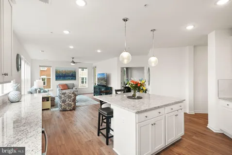 a large kitchen with granite countertop counter space a sink appliances and cabinets