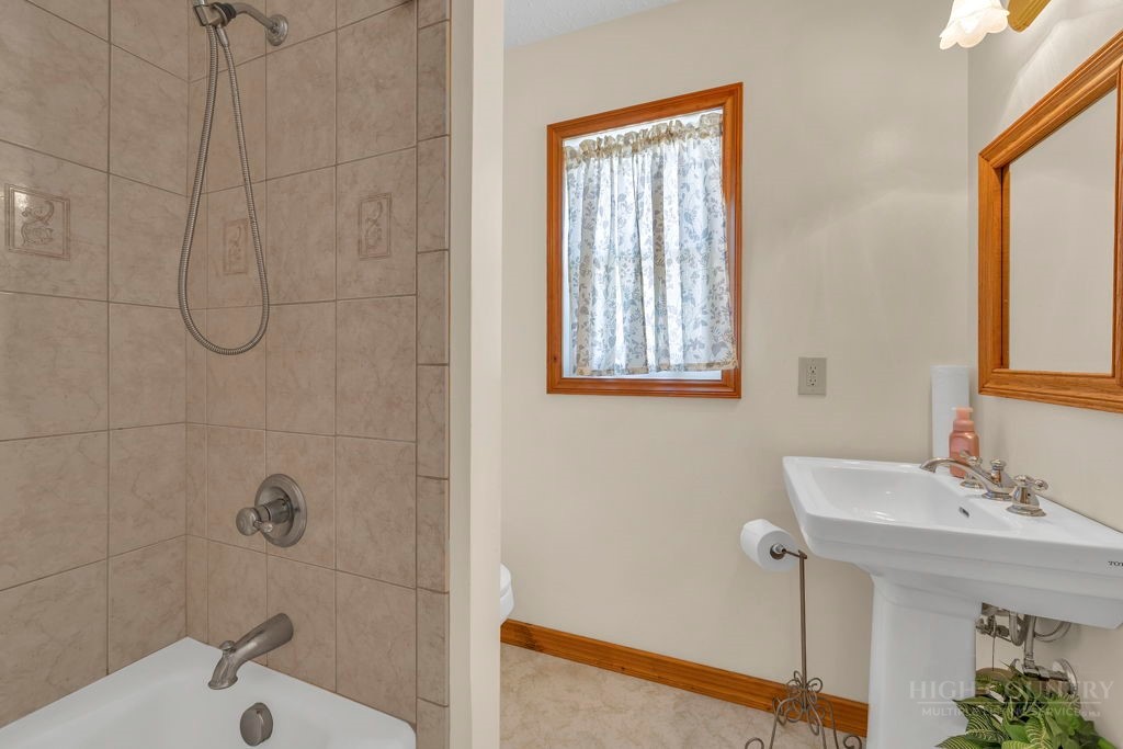 163 Rolling Hill Drive Boone, NC 28607 - Photo 21 of 40 a bathroom with a sink a window and shower