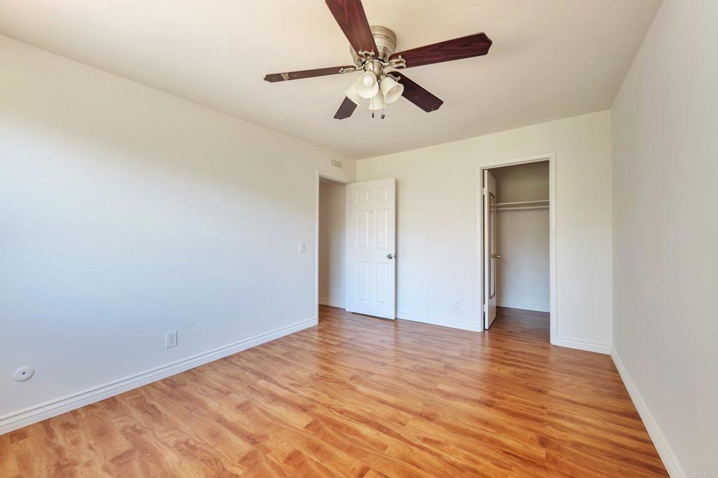 2128 Mountain Vista Drive Encinitas, CA 92024 - Photo 25 of 25 an empty room with wooden floor fan and windows