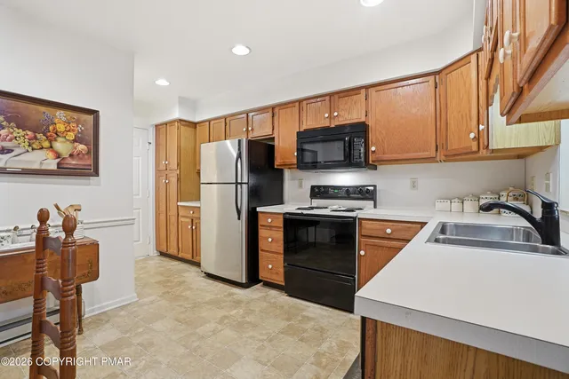 a kitchen with stainless steel appliances a refrigerator stove microwave and sink