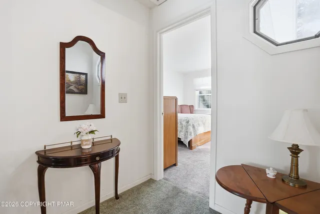 a bedroom with a bed and a flat tv screen on the dresser