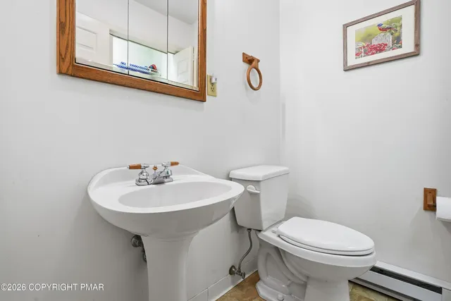 a bathroom with a sink toilet and mirror