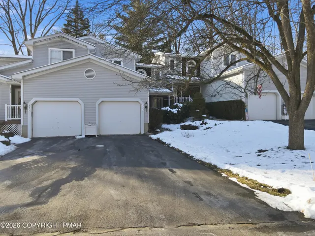 a view of a white house with a yard