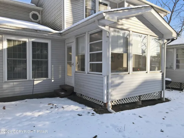 a view of a white house covered in snow