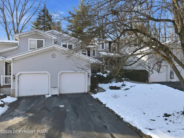 a view of a white house with a yard