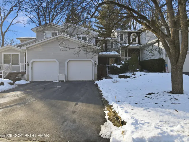 a view of a white house with a snow