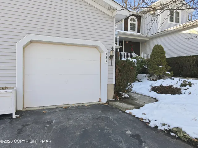 a view of a house with a snow in the background