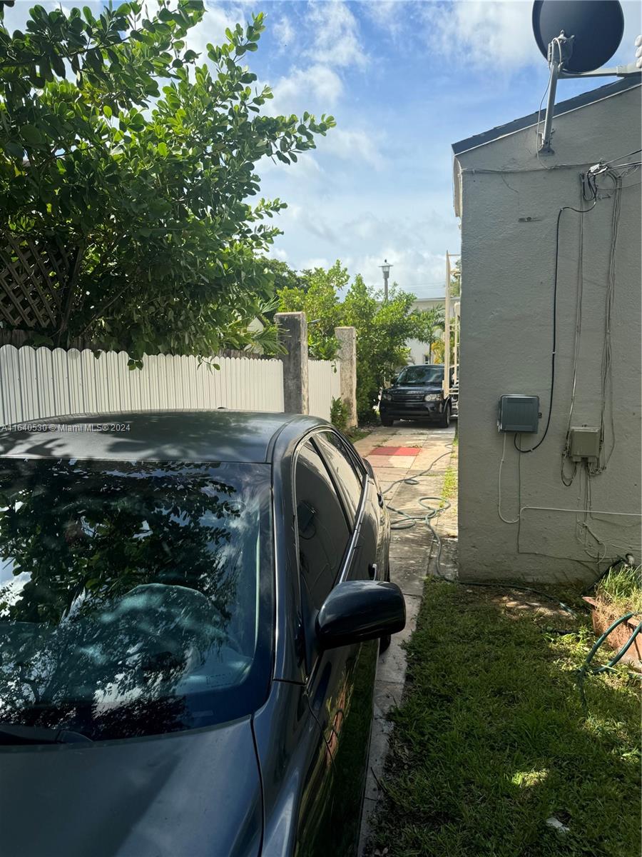 655 Northeast 80th Street Miami, FL 33138 - Photo 3 of 19 a view of balcony with a swing chair and wooden fence