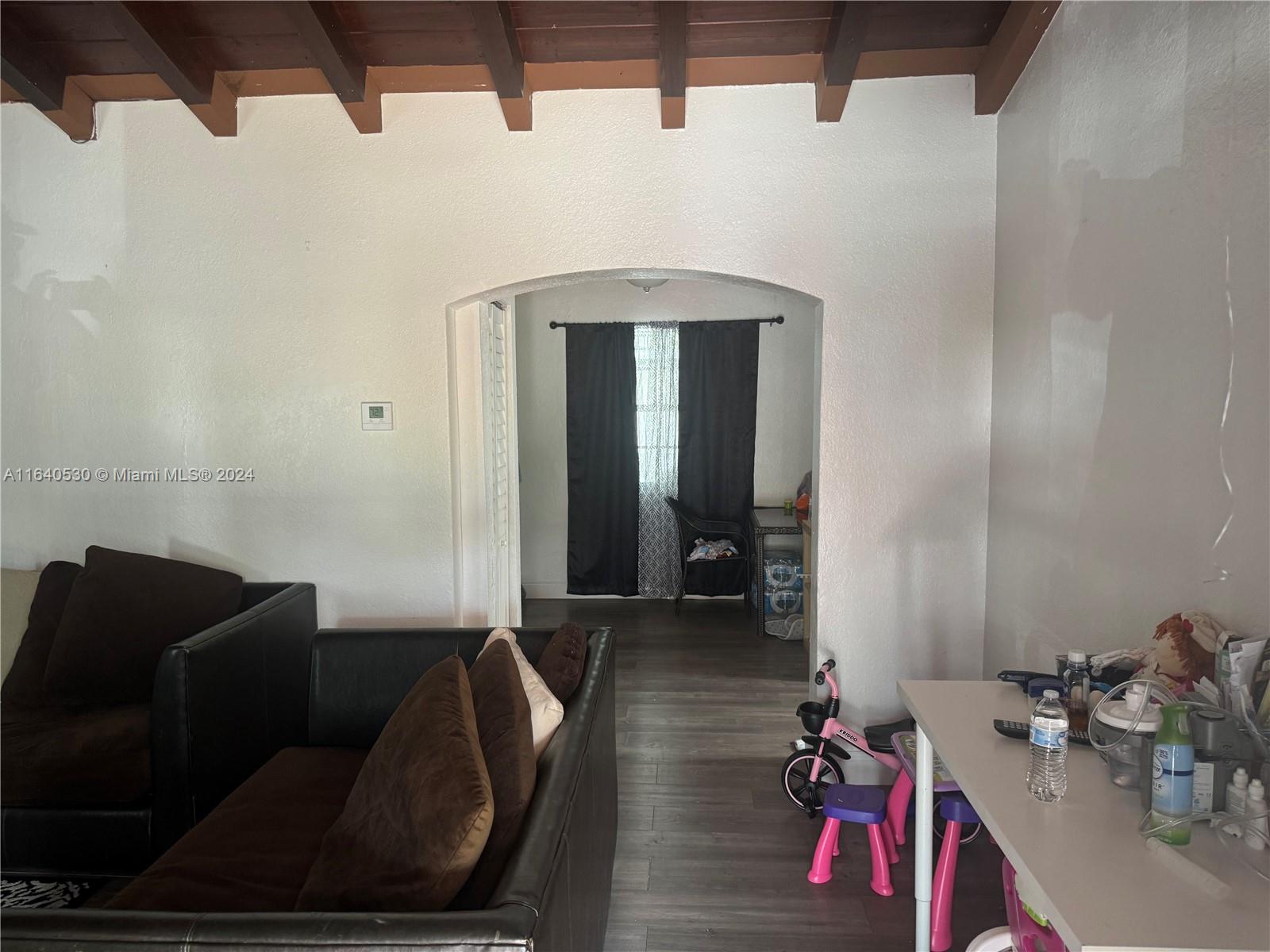 655 Northeast 80th Street Miami, FL 33138 - Photo 5 of 19 a living room with furniture and a mirror