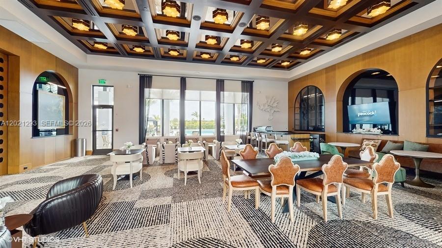 8350 Royal County Down Road Boca Raton, FL 33434 - Photo 39 of 52 a room with lots of tables a large window and chairs