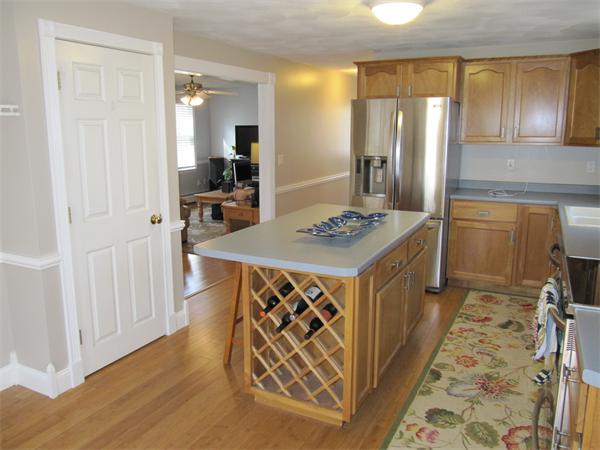 202 Warren Road Townsend, MA 01469 - Photo 12 of 30 a kitchen with stainless steel appliances granite countertop a sink stove and refrigerator