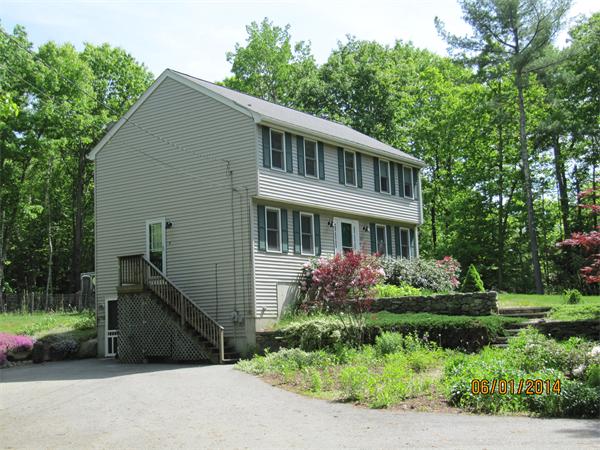 202 Warren Road Townsend, MA 01469 - Photo 4 of 30 a front view of a house with a garden