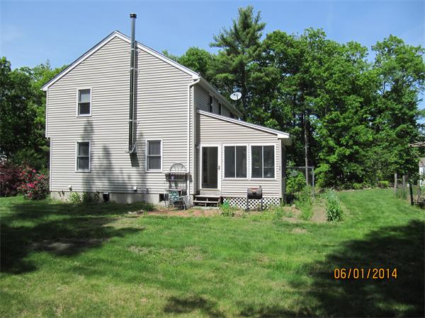 202 Warren Road Townsend, MA 01469 - Photo 10 of 30 a front view of house with yard and green space