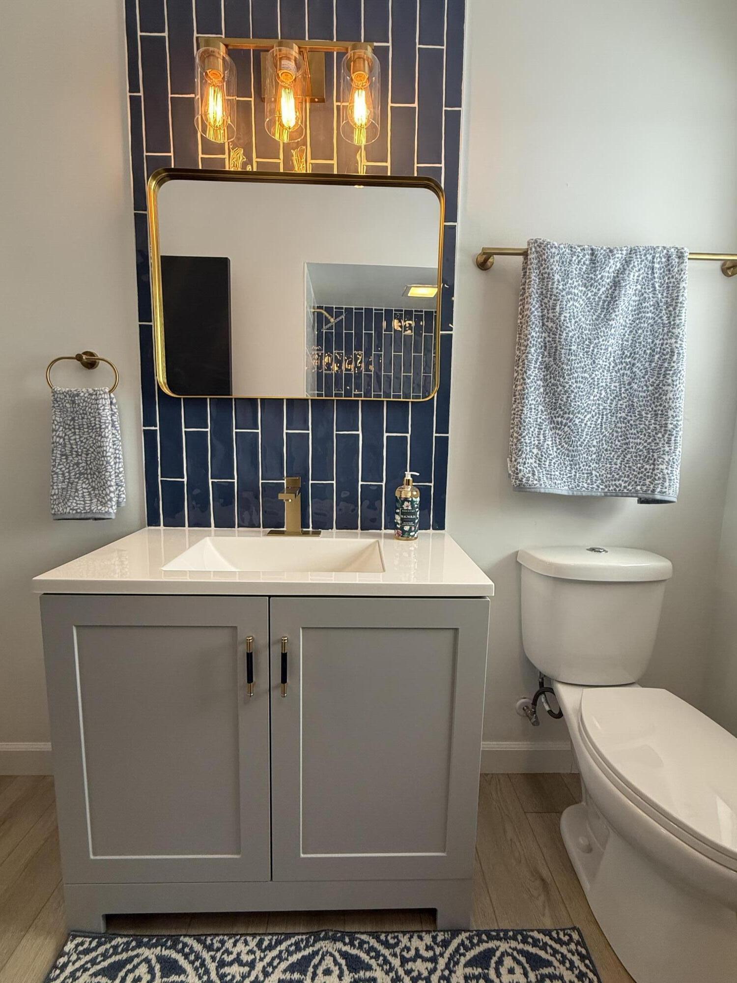 7008 Baring Avenue Hammond, IN 46324 - Photo 18 of 22 a bathroom with a toilet a sink and mirror