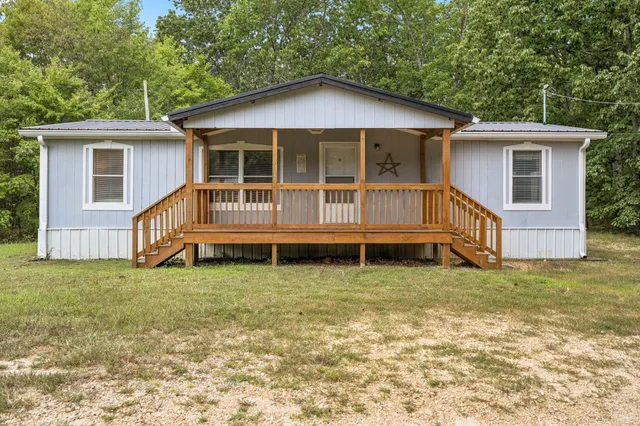 a view of a house with a yard and a large window