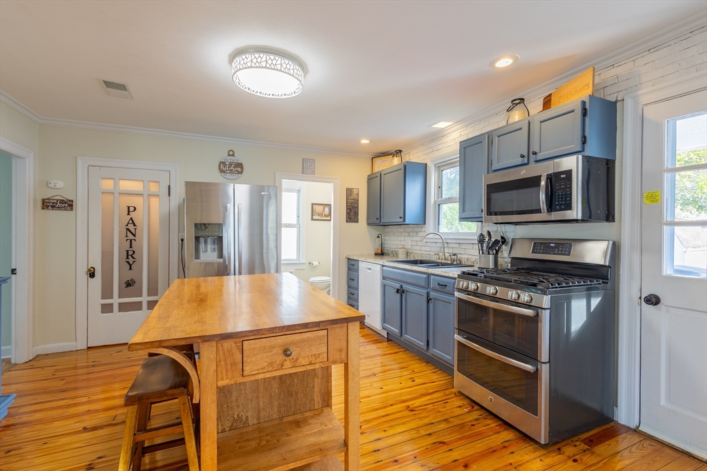 137 Papineau Avenue Woonsocket, RI 02895 - Photo 11 of 33 a kitchen with stainless steel appliances granite countertop a stove and a sink
