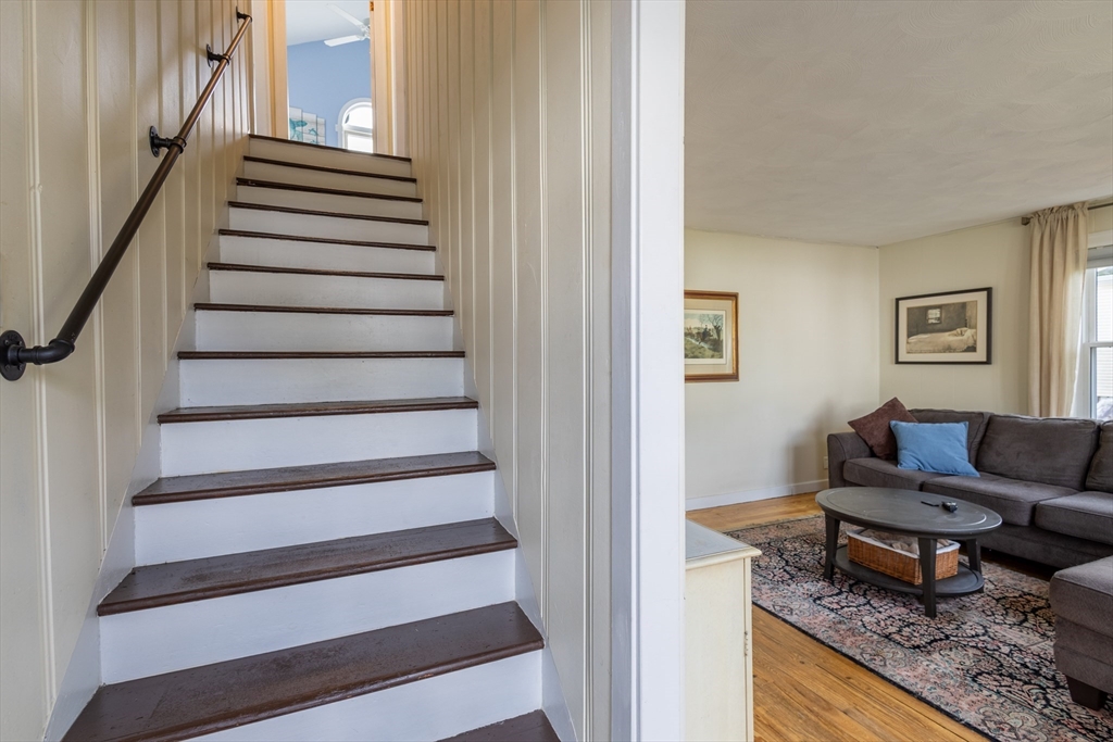 137 Papineau Avenue Woonsocket, RI 02895 - Photo 25 of 33 a living room with furniture and a stair