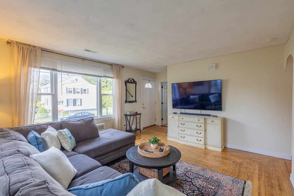 137 Papineau Avenue Woonsocket, RI 02895 - Photo 4 of 33 a living room with furniture and a flat screen tv