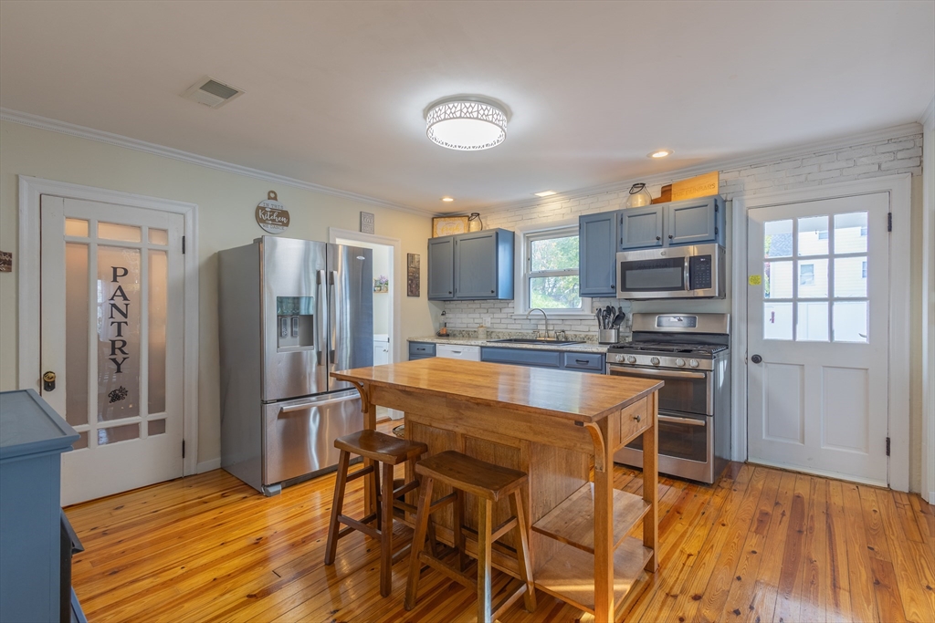 137 Papineau Avenue Woonsocket, RI 02895 - Photo 7 of 33 a kitchen with stainless steel appliances granite countertop a refrigerator and a stove top oven