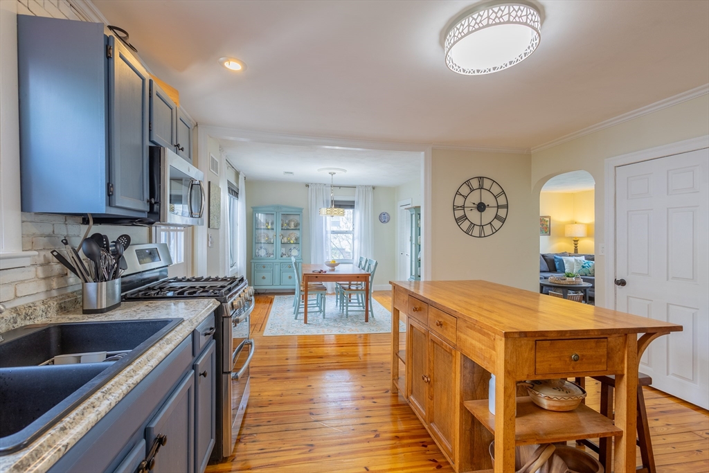 137 Papineau Avenue Woonsocket, RI 02895 - Photo 8 of 33 a kitchen with stainless steel appliances granite countertop a sink stove and wooden cabinets