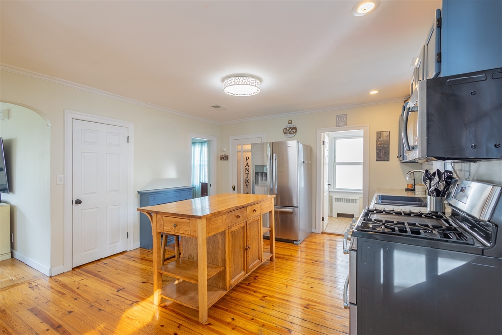 137 Papineau Avenue Woonsocket, RI 02895 - Photo 10 of 33 a kitchen with stainless steel appliances granite countertop a stove and a refrigerator