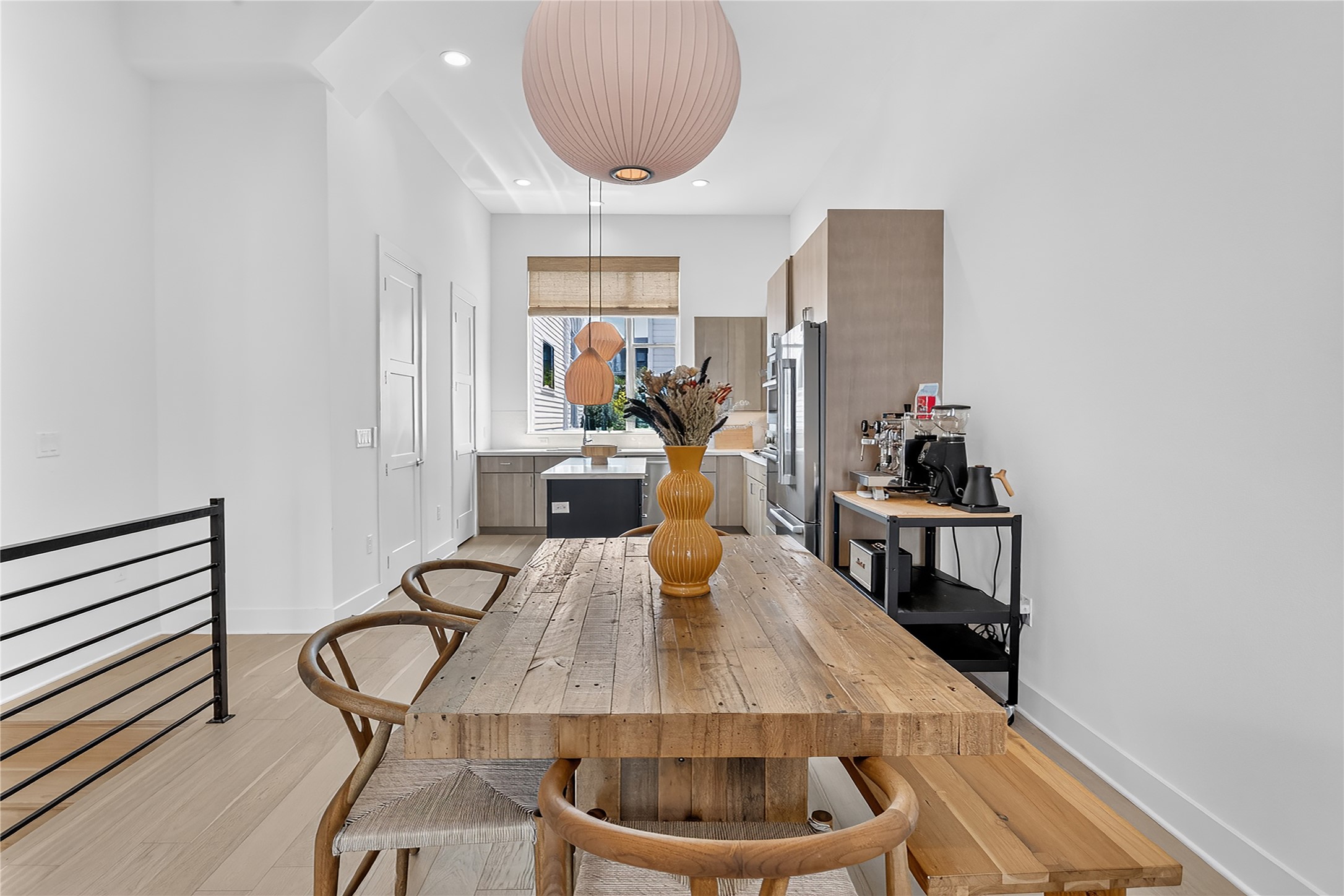 2805 McCurdy Street, Unit 14 Austin, TX 78723 - Photo 11 of 40 Blonde hardwood floors extend through this airy dining space, leading to a contemporary kitchen.