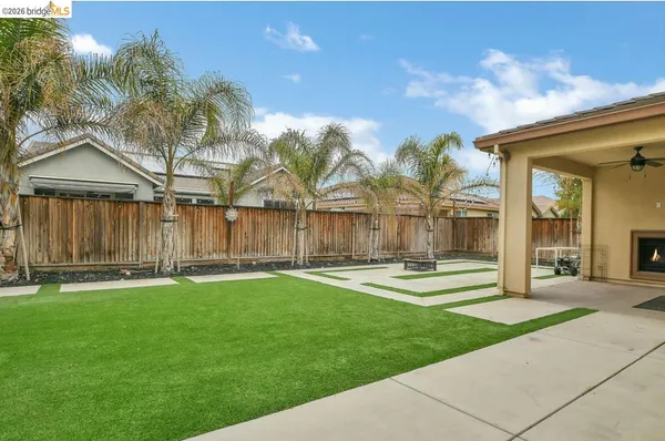 a backyard of a house with table and chairs
