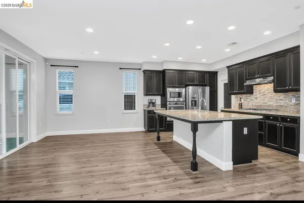 a kitchen with kitchen island granite countertop wooden cabinets and counter space