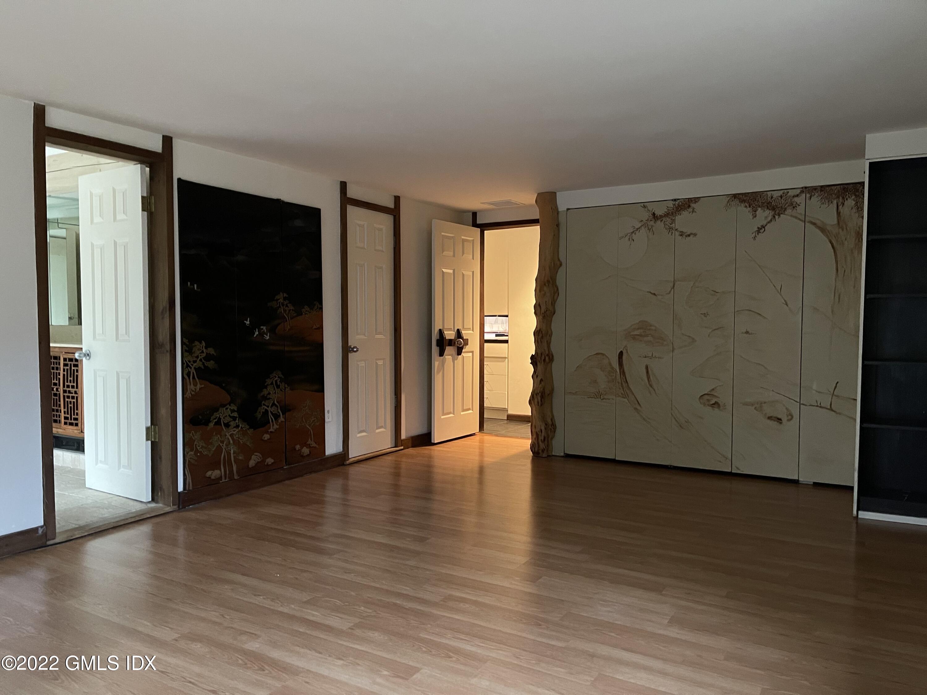 331 Stanwich Road Greenwich, CT 06830 - Photo 12 of 28 an empty room with wooden floor and closet