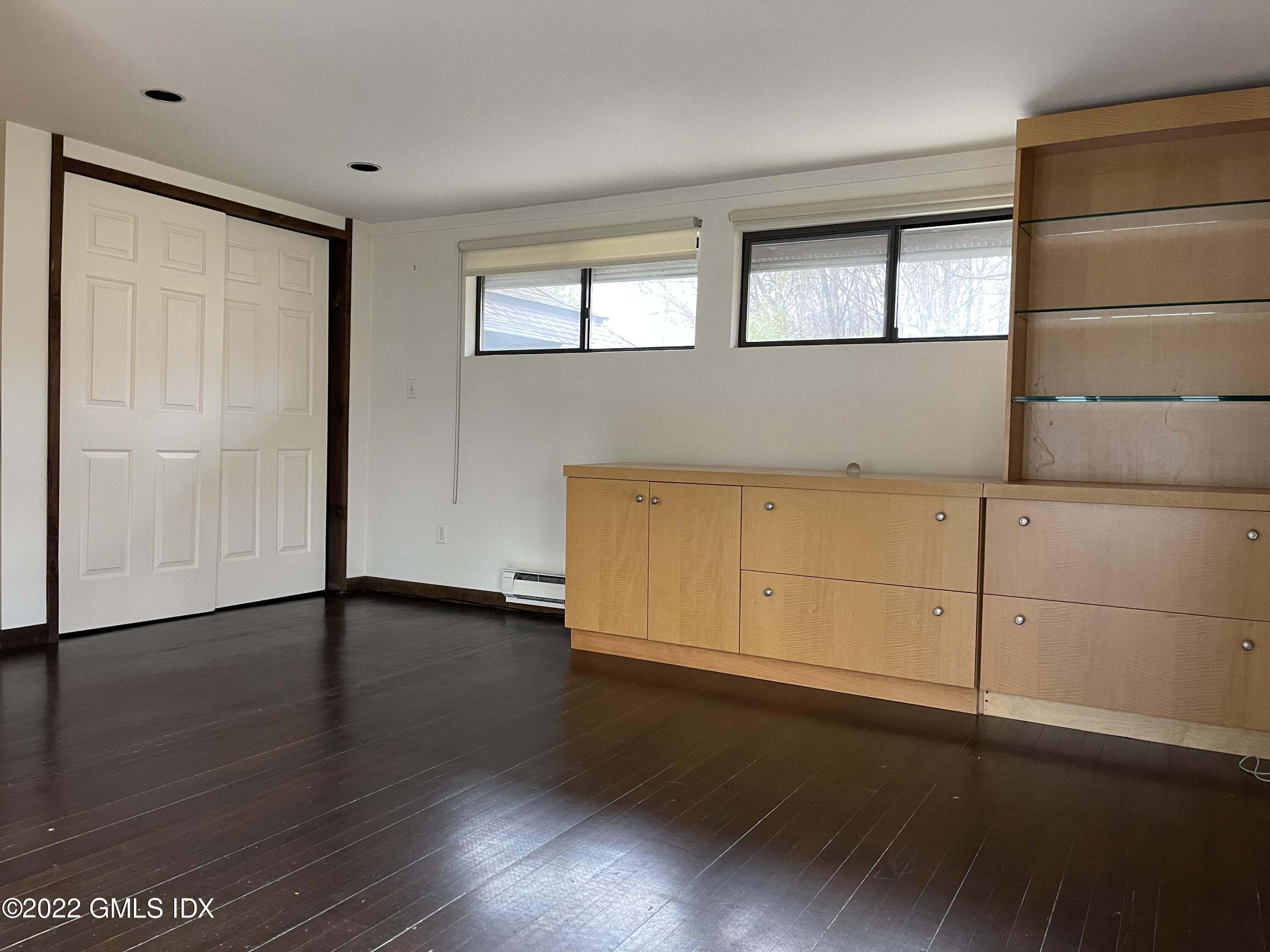 331 Stanwich Road Greenwich, CT 06830 - Photo 17 of 28 an empty room with wooden floor and cabinet