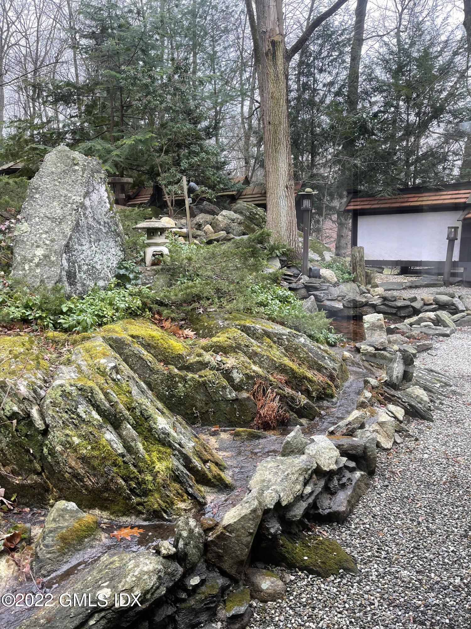 331 Stanwich Road Greenwich, CT 06830 - Photo 21 of 28 a backyard of a house with a yard and outdoor seating