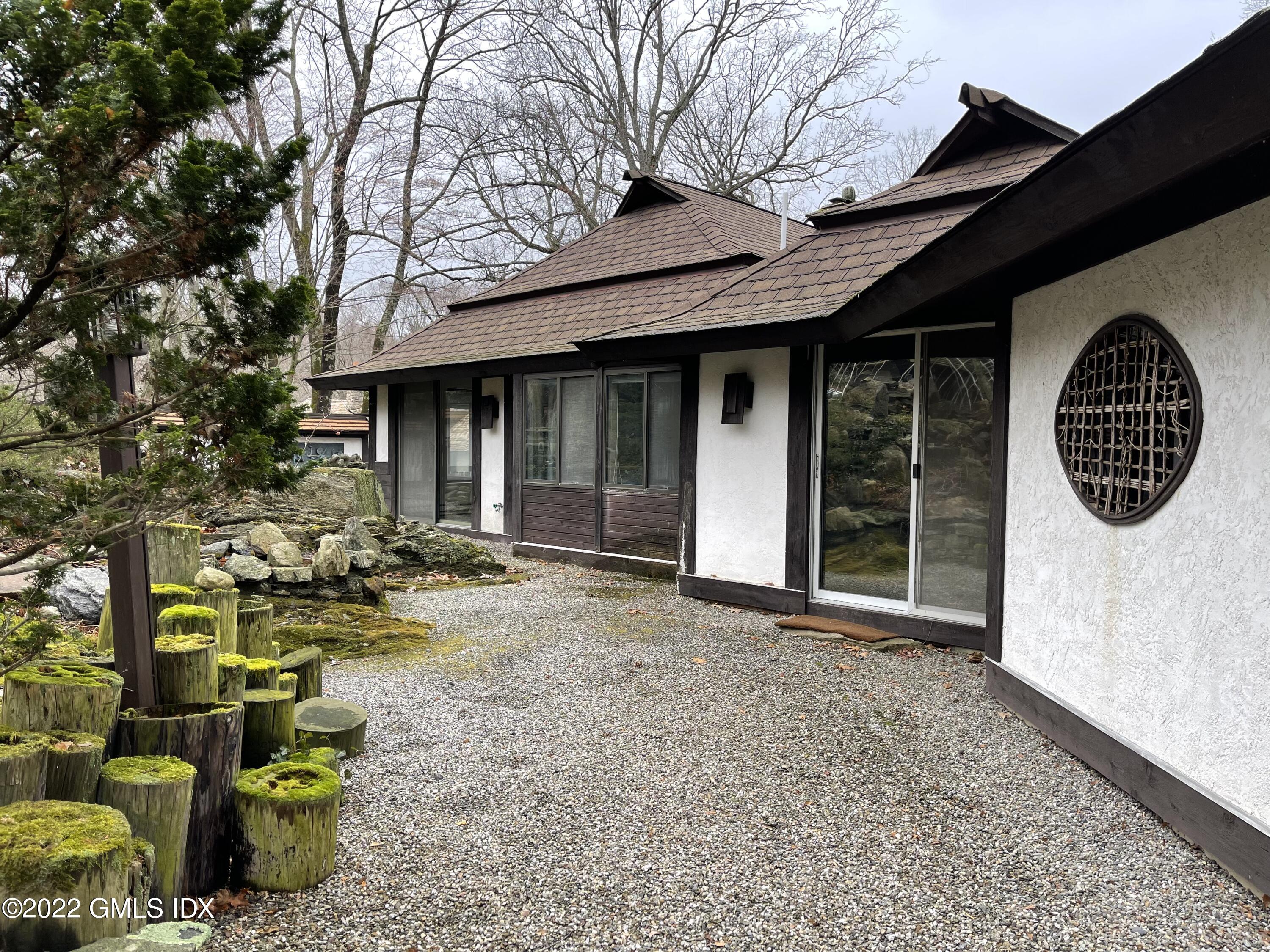 331 Stanwich Road Greenwich, CT 06830 - Photo 24 of 28 a view of a chair and table in backyard of the house