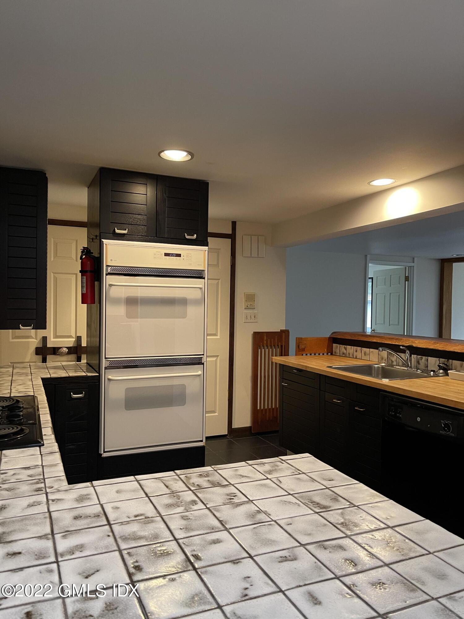 331 Stanwich Road Greenwich, CT 06830 - Photo 7 of 28 a kitchen with a refrigerator and a stove top oven