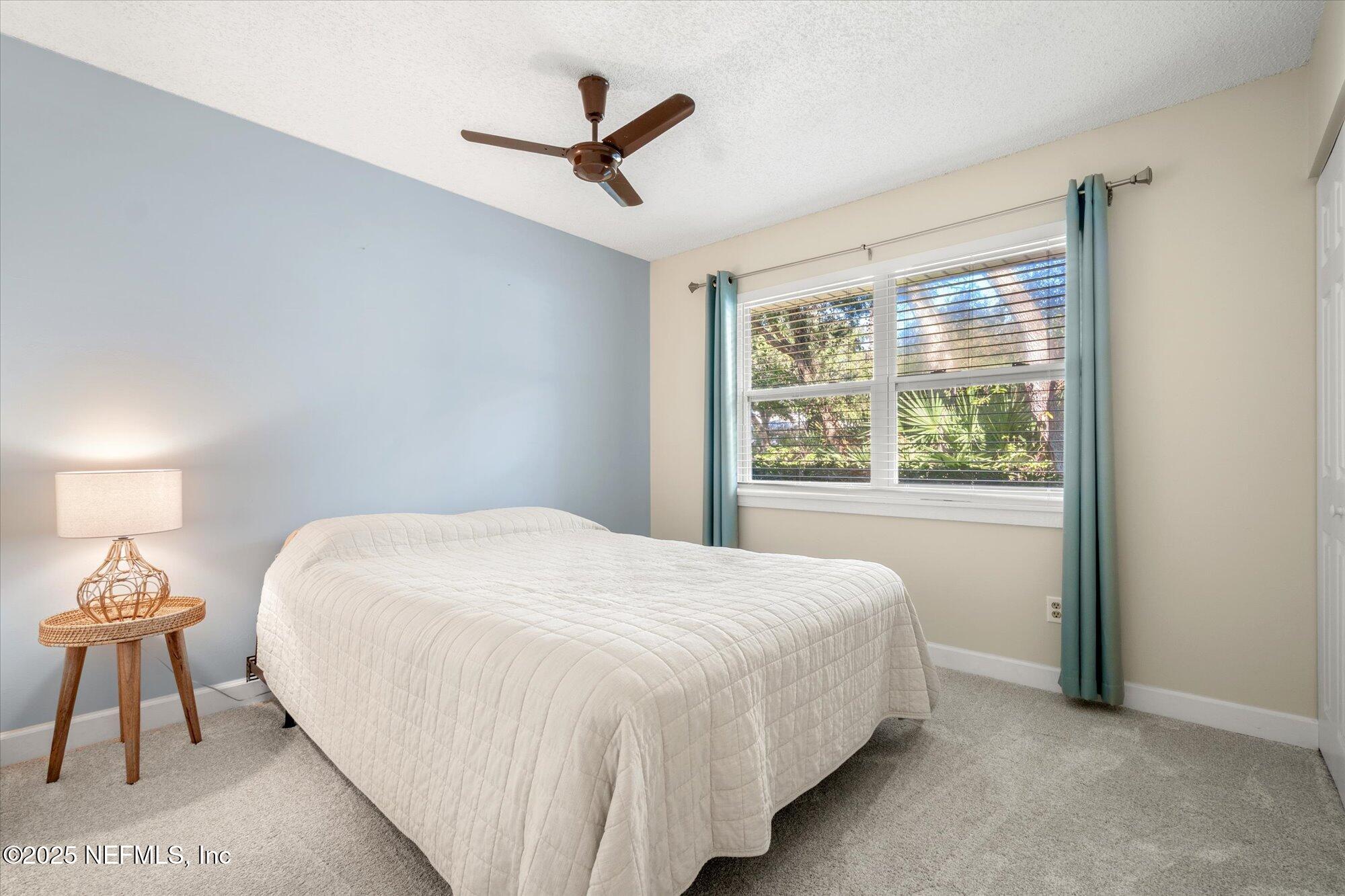 904 San Jose Road St. Augustine, FL 32086 - Photo 11 of 31 a bedroom with a bed and a window