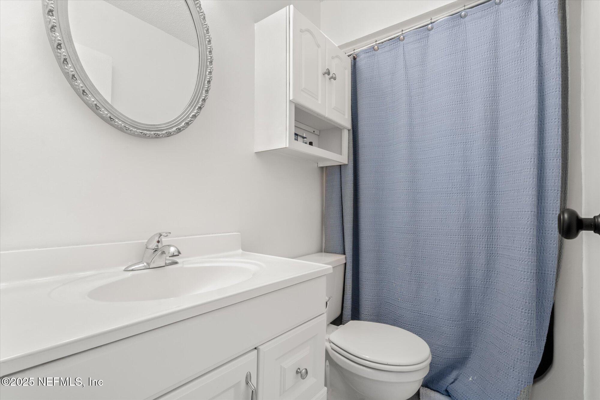904 San Jose Road St. Augustine, FL 32086 - Photo 19 of 31 a bathroom with a sink a toilet and a mirror