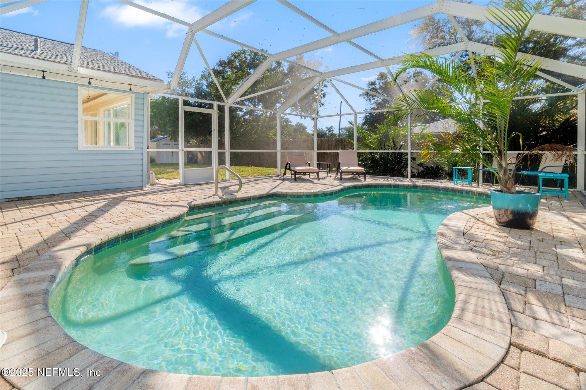 904 San Jose Road St. Augustine, FL 32086 - Photo 29 of 31 a view of a backyard with table and chairs potted plants