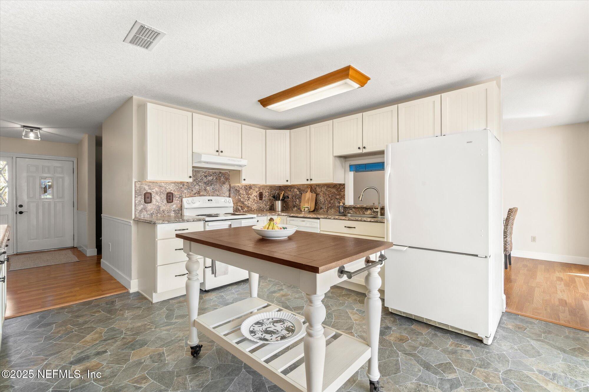 904 San Jose Road St. Augustine, FL 32086 - Photo 6 of 31 a kitchen with stainless steel appliances granite countertop a refrigerator and a stove top oven