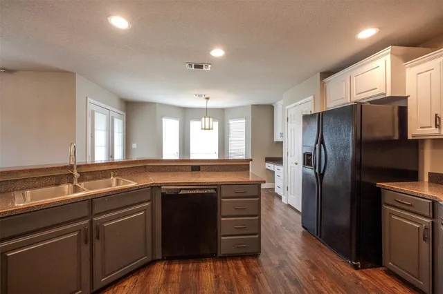 a kitchen with a sink and refrigerator